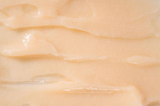 Hair conditioner cream background. Yellow cosmetic lotion moisturiser sample closeup. Body care balm, retinol serum, shampoo wavy texture. Skincare mask smear, creamy cleanser product swatch
