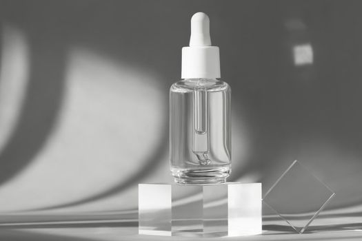 Serum bottle with peptides and retinol product packaging on modern acrylic transparent blocks with shadows from sun, cosmetic mockup on geometric stand, pedestal, cosmetics podium, skincare concept