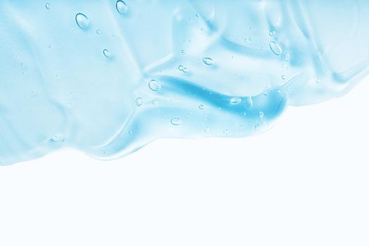Cream gel blue transparent cosmetic sample with bubbles isolated on white background. Face serum texture. Clear skincare product smudge closeup. Hand sanitizer, hygiene liquid gel. Copy space