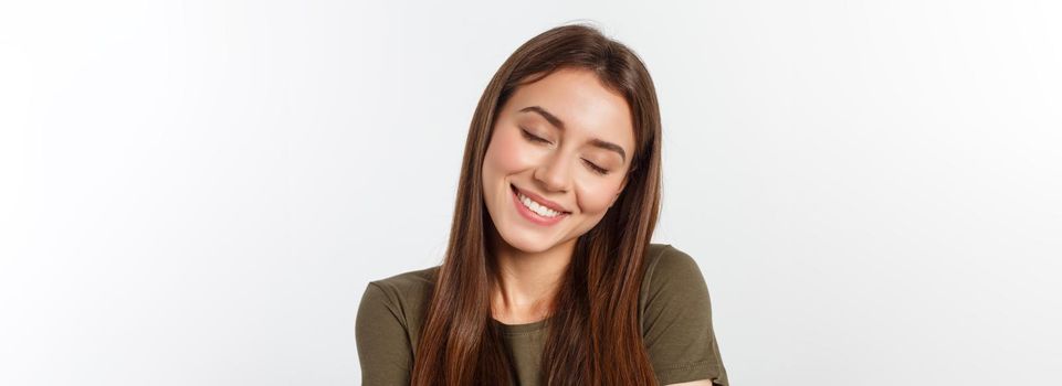 Portrait of a beautiful young woman looking at the camera and smiling, isolated on a white background