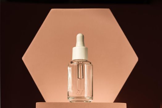 Serum product cosmetic with peptide and collagen on brown surface. Hyaluronic acid, serum skincare bottle on beige podium pedestal. Modern brand packaging with shadows. Cosmetic showcase