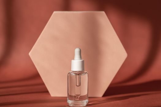 Hyaluronic acid, serum skincare bottle on beige podium pedestal. Serum product cosmetic with peptide and collagen on brown surface. Modern brand packaging with shadows. Cosmetic showcase