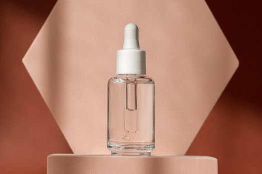 Hyaluronic acid, serum skincare bottle on beige podium pedestal. Cosmetics organic serum product with peptide and collagen on brown surface. Modern brand packaging with shadows. Cosmetic showcase