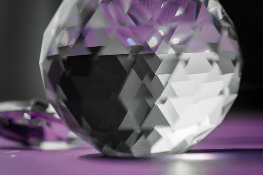 Crystal prism refracting light, magic crystals and pyramid, sphere and cube on purple background. Spiritual healing crystal practice. Feng Shui, good energy flow concept, esoteric background..