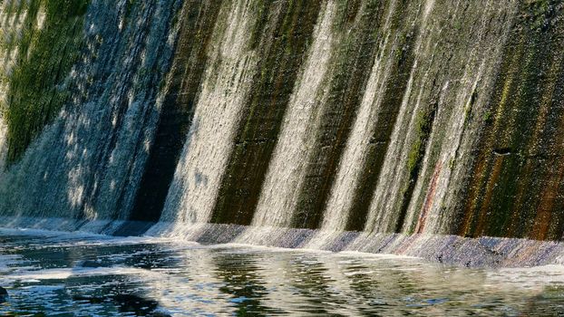 a barrier constructed to hold back water and raise its level, forming a reservoir used to generate electricity or as a water supply.