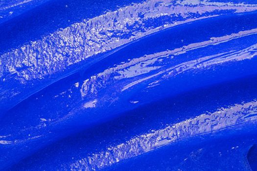 Blue gel texture. Cosmetic clear liquid cream smudge. Skin care product sample closeup. Toothpaste or wax background