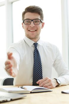 Smiling businessman pleased to meet you at office