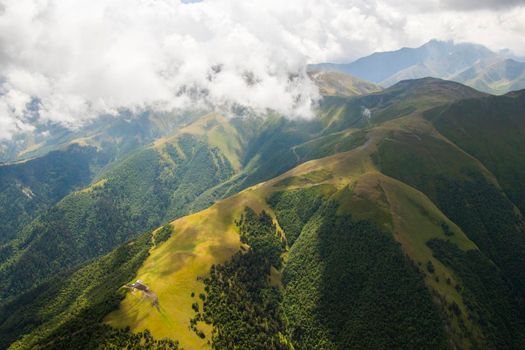 Tusheti mountain landscape and view, high angle, Georgian nature, clouds and forest