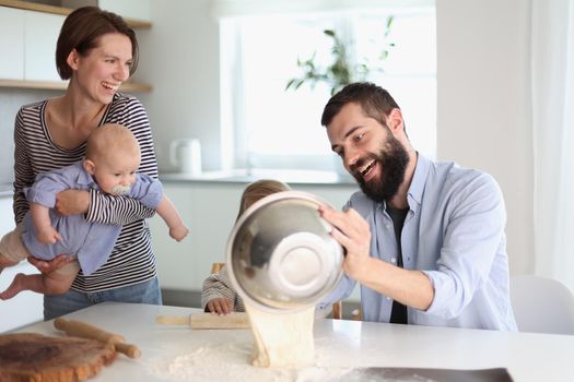 Young family with daughter and son in the kitchen