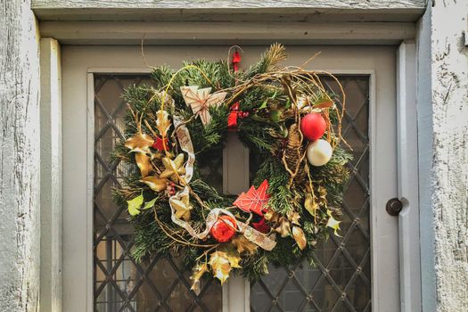 Gold christmas wreath on a gray shabby door