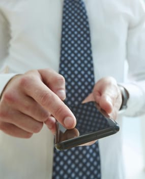 Businessman using phone for celling and texting on her mobile phone