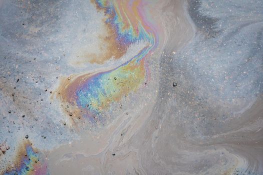 Color Gasoline fuel spots on Asphalt Road as Texture or Background. Environmental pollution concept