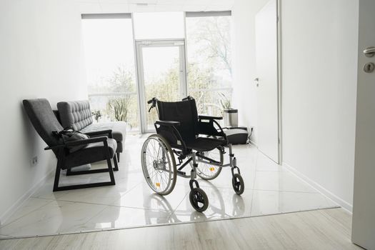 Modern wheelchair in empty hospital hall. Medical equipment. High quality photo