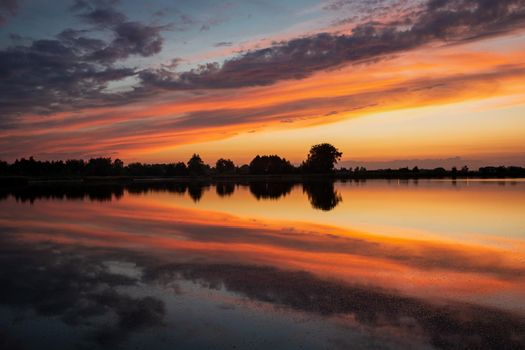 Colorful clouds reflected in the lake water after sunset