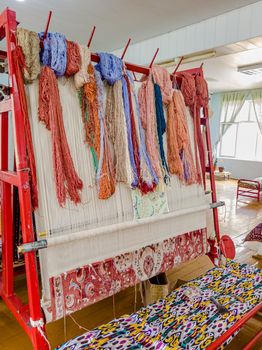 Workshop for the manual production of silk carpets in Central Asia. Uzbekistan.