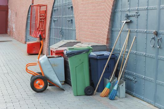 Equipment for cleaning city streets: a broom, a garbage container, a trolley. Clean city concept
