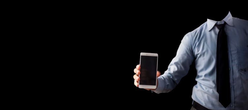 Shot of a well dressed employee holding an smartphone in his hand isolated on black background.