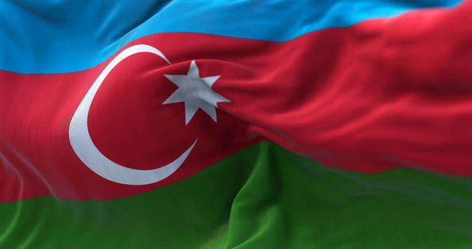 Close-up view of the azerbaijani national flag waving in the wind. Azerbaijan is a transcontinental country located at the boundary of Europe and Asia. Fabric textured background. Selective focus