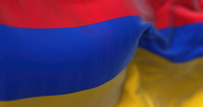 Close-up view of the armenian national flag waving in the wind. Armenia is a landlocked country located in the Armenian Highlands of Western Asia. Fabric textured background. Selective focus