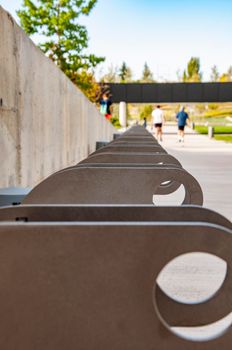 bicycle parking on close view. Madrid city business area.People enjoy walking in nature in the background