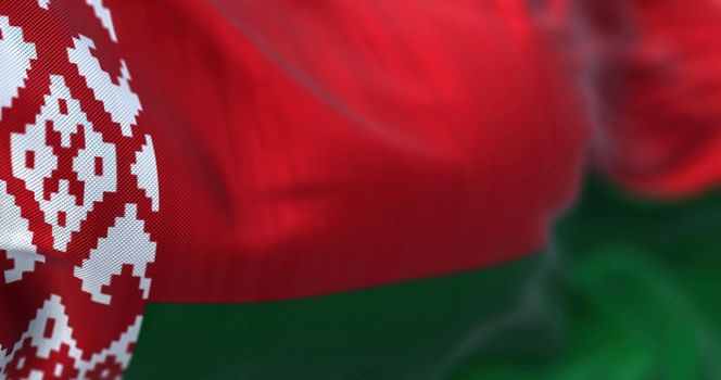 Close-up view of the belarusian national flag waving in the wind. The Republic of Belarus is a landlocked country in Eastern Europe. Fabric textured background. Selective focus