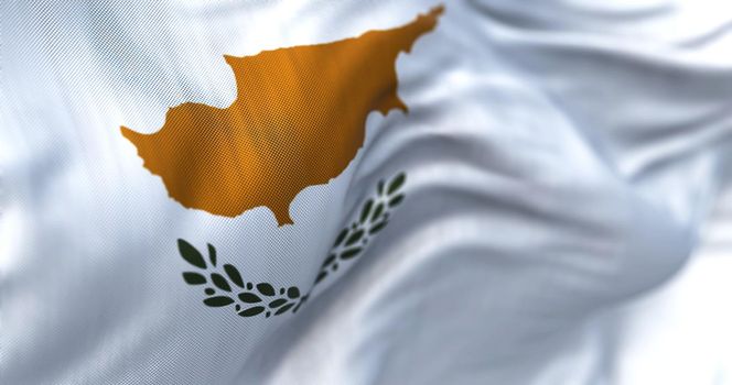 Close-up view of the cypriot national flag waving in the wind. The Republic of Cyprus is an island country in the eastern Mediterranean Sea. Fabric textured background. Selective focus