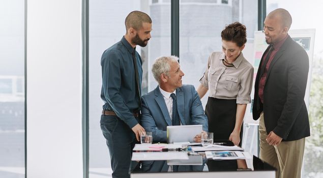 She looks impressed. a group of businesspeople in the boardroom