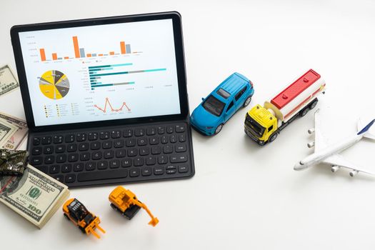 different types of toy transport and a tablet.