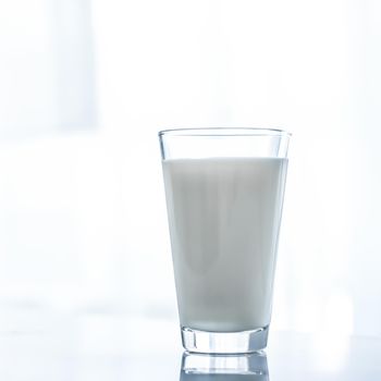 Dairy, healthy nutrition and breakfast concept - World Milk Day, full glass on marble table