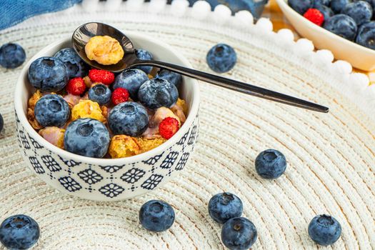Healthy breakfast concept. Granola with blueberries and strawberries in the white bowl. muesli with fresh berries. Fresh healthy breakfast for weight loss. Classic american breakfast on the table