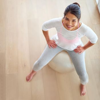 Im doing this for me. High angle shot of a young woman sitting on a swiss ball