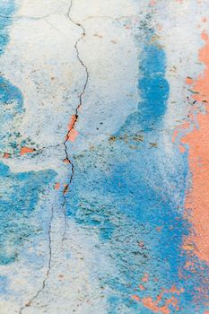 Old blue-pink wall covered with cracks background
