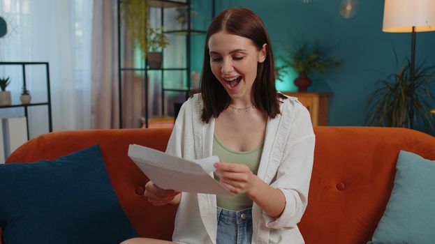 Happy woman open envelope letter, reading it. Career growth advance promotion, bank loan approve, successful admission to university monetary award long-awaited invitation great news, lottery game win