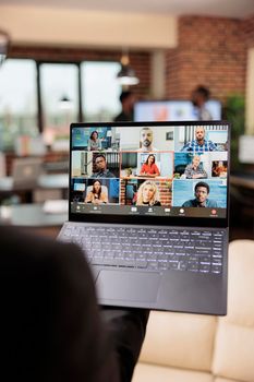 Female freelancer talking on online videocall conference with business people, using remote teleconference chat on internet meeting with webcam. Chatting on videoconference in company office.