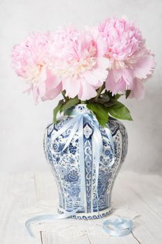 spring still life with bouquet of pink luxurious peonies in an ancient Chinese vase with blue ornament, High quality photo