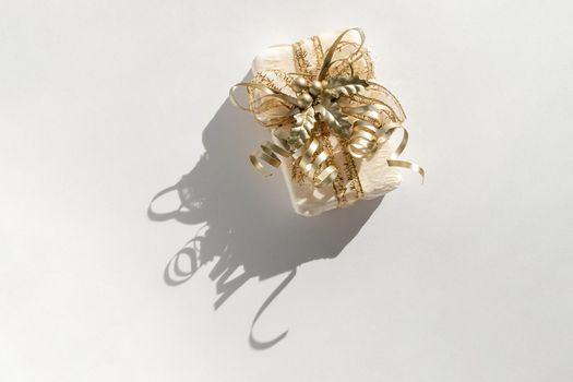 Christmas gift present with golden decor isolated on white background, top view, above