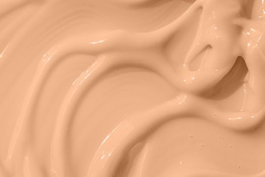 Cosmetic tonal moisturizer, bb cream swatch sample. Beige nude liquid foundation texture, concealer smear smudge drop. Make up base, cream textured background. Closeup macro