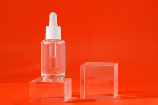 Mock up packaging, product design branding. Cosmetic serum liquid mockup in transparent bottle on acrylic cubes. Serum skin care product on red background with shadows, hyaluronic acid oil.