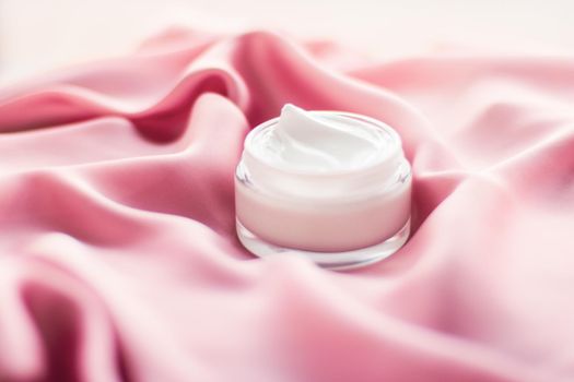 Beauty, anti-age cosmetics and skincare concept - Luxury face cream jar on a soft pink silk