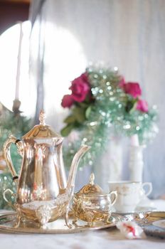 Tea break in English style, vintage silver service against the background of New Year's decor, festive still life, shallow depth of field, light and air