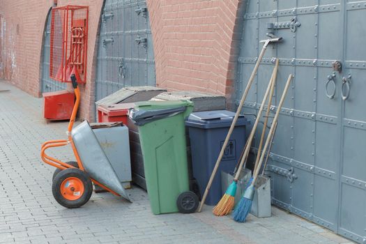 Equipment for cleaning city streets: a broom, a garbage container, a trolley. Clean city concept