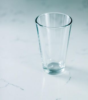 Glassware, washing and purity concept - Clean empty glass on marble table