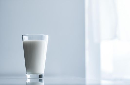 Dairy, healthy nutrition and breakfast concept - World Milk Day, full glass on marble table