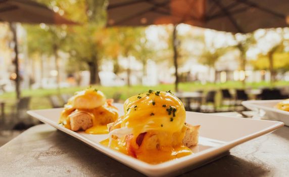 Restaurant service, food recipes and breakfast concept - Poached egg with salmon for brunch in a luxury restaurant