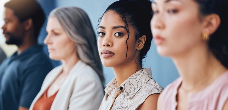 Training, learning and education with a business woman looking serious and sitting in a conference or workshop for coaching. Portrait of a female employee in an audience for a development seminar.