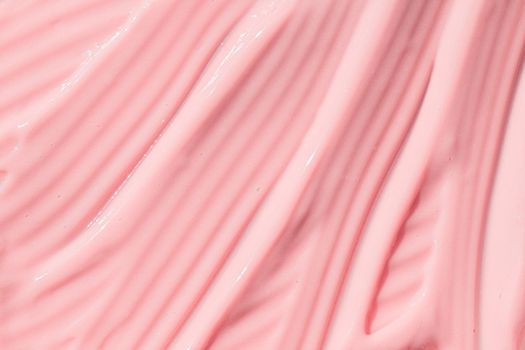 .Creamy pink skincare lotion mousse product closeup. Peach cream, moisturizer, shampoo spread, sunscreen cosmetic smear background. Moisturizing beauty creme, balm swatch, pink paint, yogurt texture