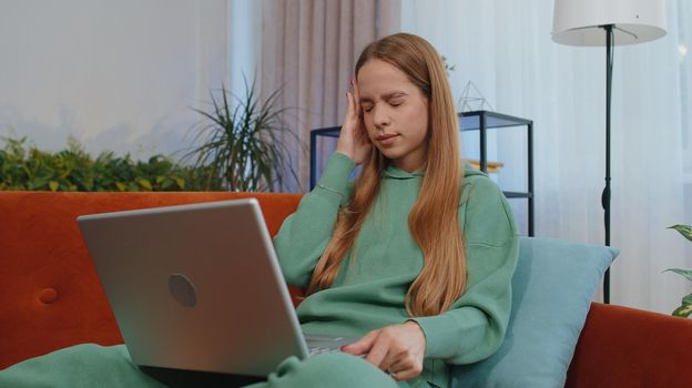 Tired student girl child kid freelancer use laptop, suffering from headache problem tension and migraine, stress. Young woman works on notebook, sends messages, makes online purchases, watching movies