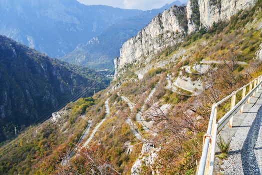 Serpentine mountain road, picturesque Alps autumn landscape. Lombardy, Italy. Tourist adventure