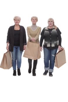 in full growth. three happy women with shopping bags. isolated on a white background.