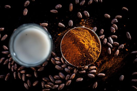Face mask consisting of coffee powder and milk on the black colored surface for naturally glowing skin.